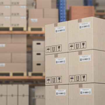 Warehouse with cardboard boxes to represent efficient and reliable production process